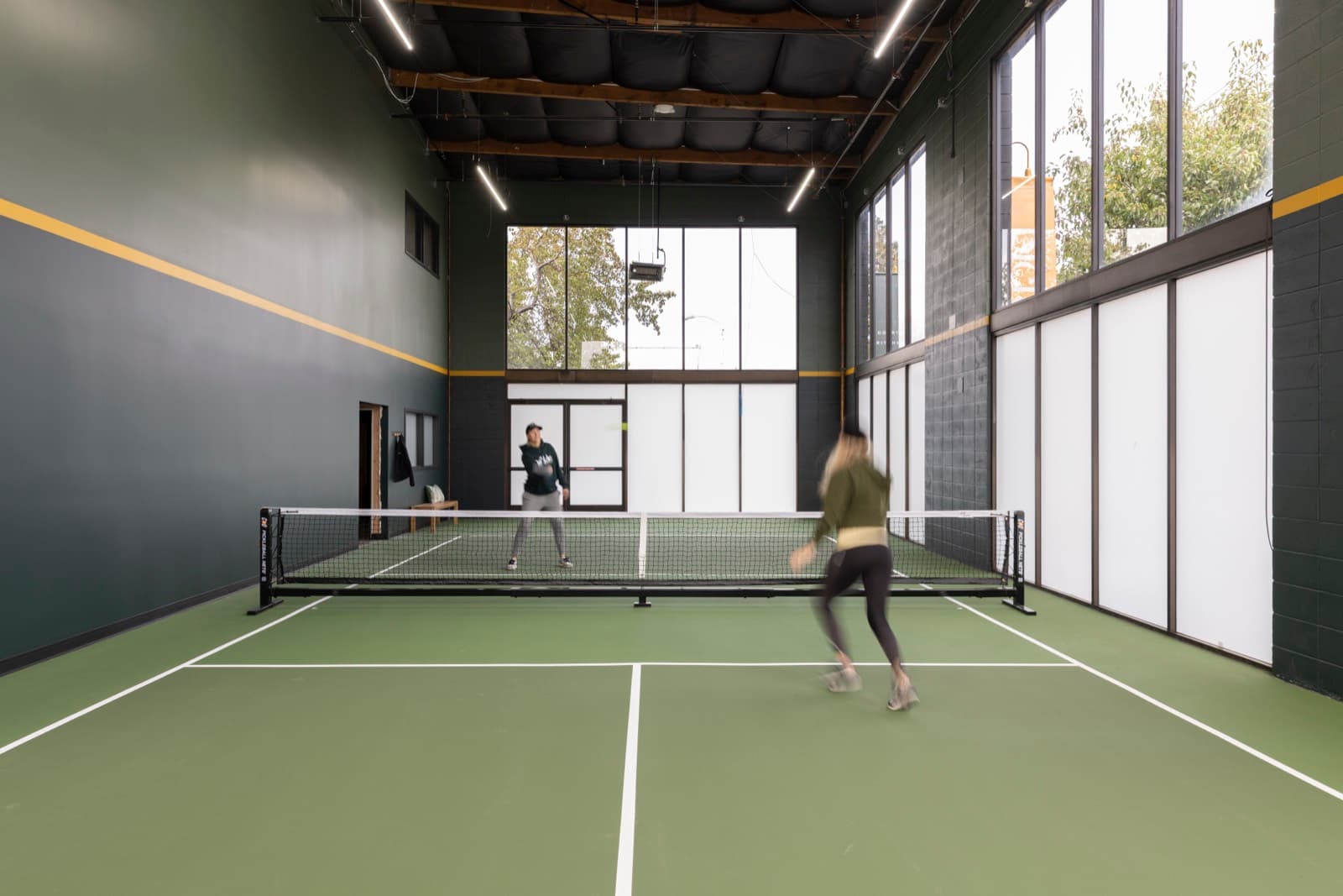 Players rallying on the indoor court at Pickle Athletics in Oakland